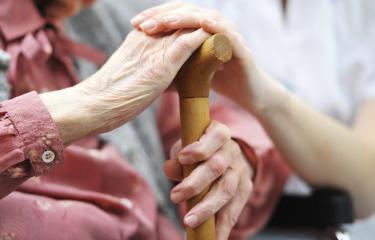 Elderly patient holding cane
