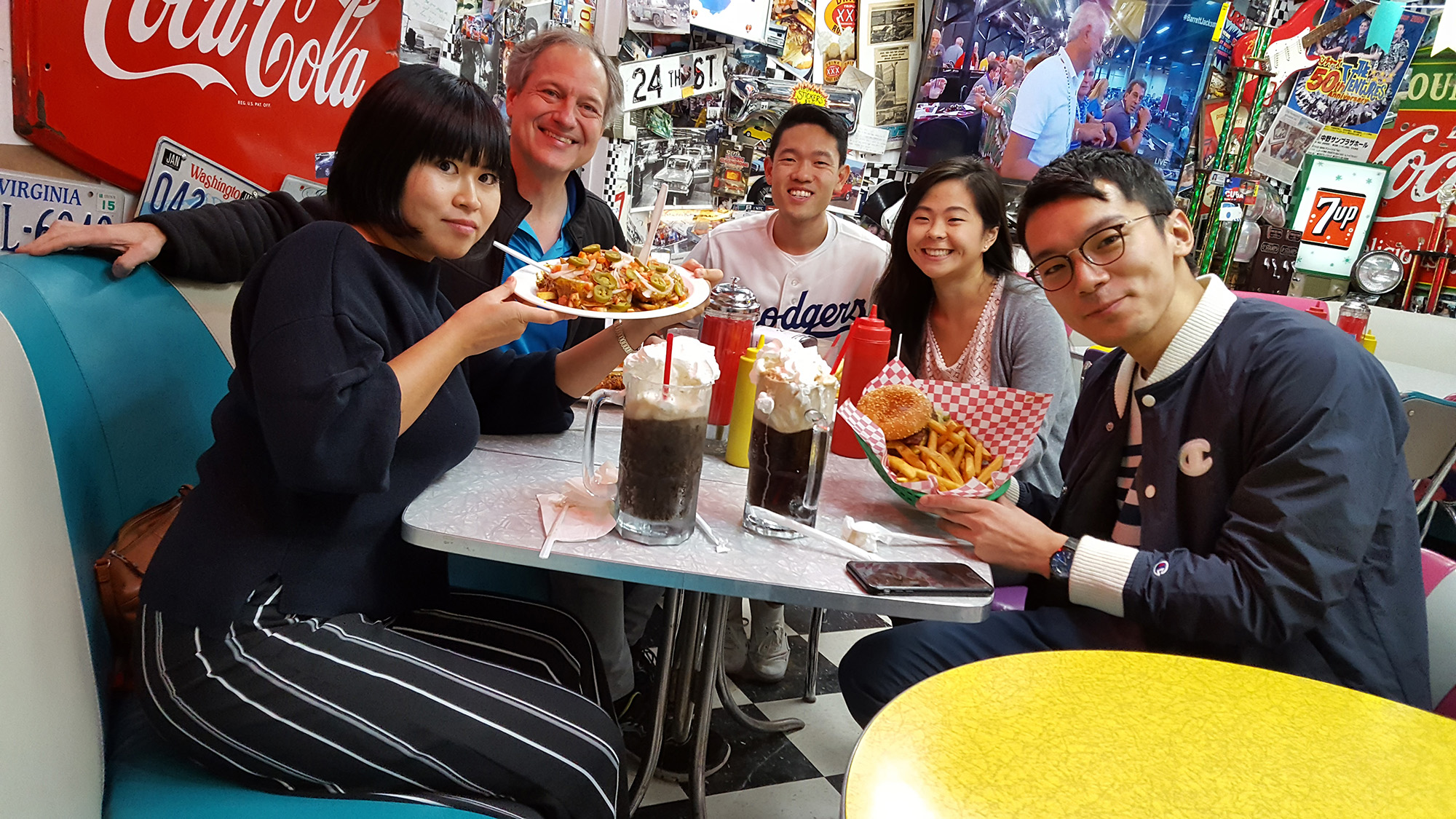 Visiting students from Shimane, Japan having an american lunch of burgers, fries and soda.