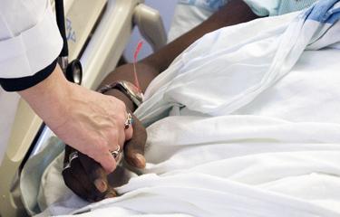 Doctor holding patient's hand